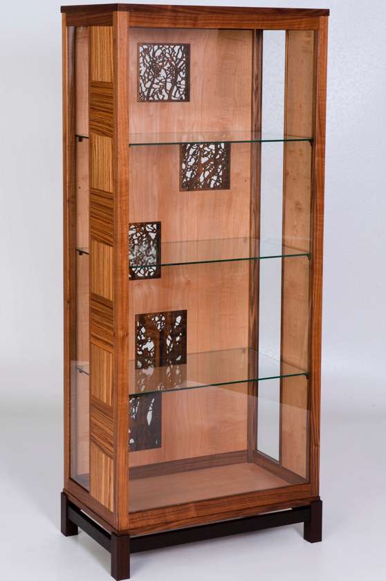 Many of Jason Klager’s designs have a distinct Asian influence. He used black walnut, western maple, zebrano, wenge & imbuya woods with pierced carvings of branches in his “Autumn’s Display” cabinet. Photo: focalpointestudios.ca